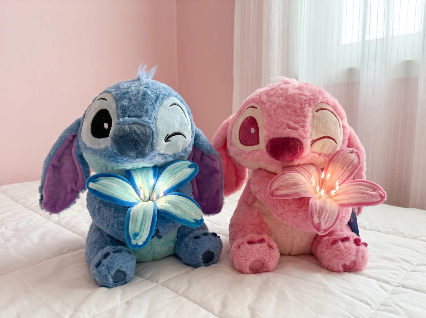 The two plushies styled in a cozy bedroom